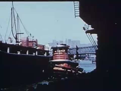 tugboat on the water seen from beneath the el structure