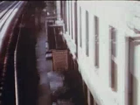 view looking down an alleyway between brick buildings from the train