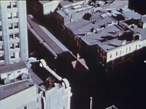 high aerial view of city rooftops and streets