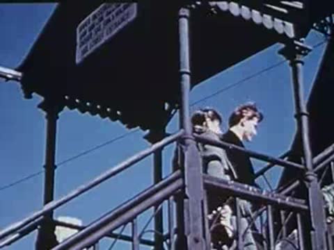 man and woman standing on a station platform outdoors