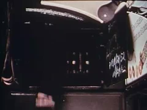hand pulling down a news vendor flap on a train