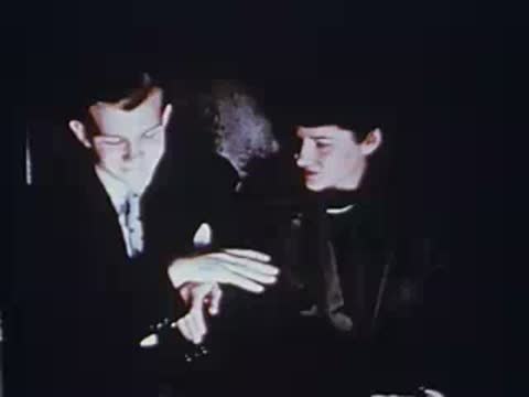 man and woman sitting together looking down inside a vehicle