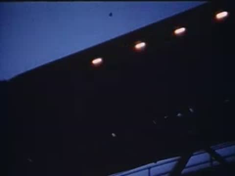 man and woman sitting together followed by shot of train exterior at night