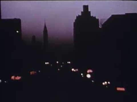 city skyline at dusk with distant streetlights glowing