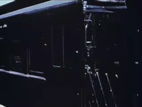 Dark interior view of a train carriage as a passenger boards.