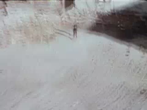 Aerial view of pedestrians walking on street corner, urban environment, archival footage.
