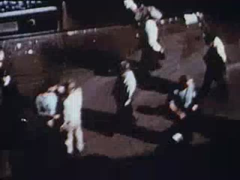 People walking and standing on busy city sidewalk, urban street, archival footage.