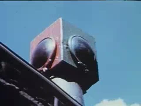 Architectural detail of rooftop structure against blue sky, archival footage.