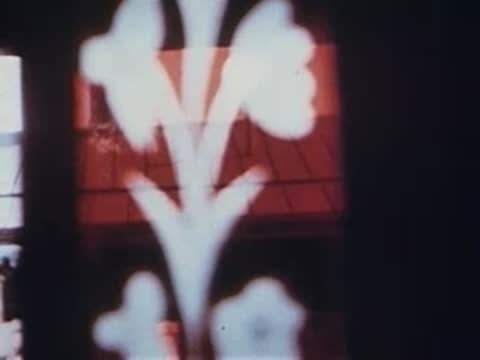 Close-up of decorative floral pattern on train window or glass, archival footage.