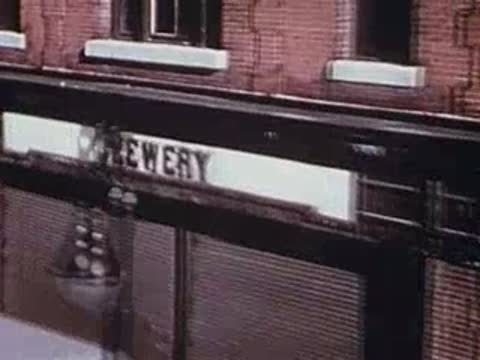building exterior with brewery sign, moving past window