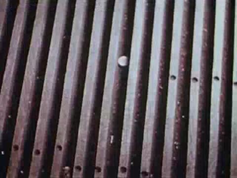 man walking inside train car and looking down