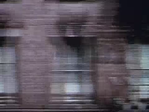 brick building exterior moving past train window rapidly