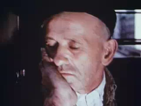 Close-up of a tired man resting his head on his hand.