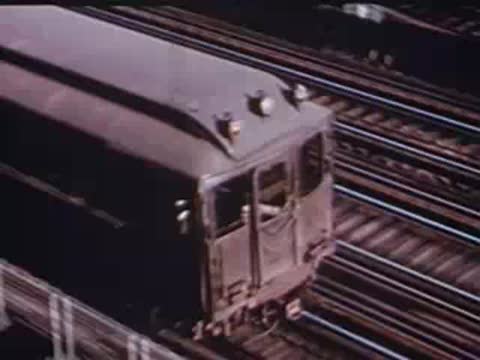 Elevated train arriving at station and passengers stepping down.