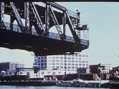 bridge structure fully raised with city skyline in the background