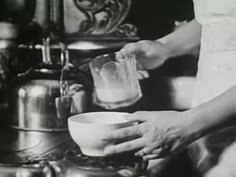 Woman pouring milk from a pitcher into a small white bowl.