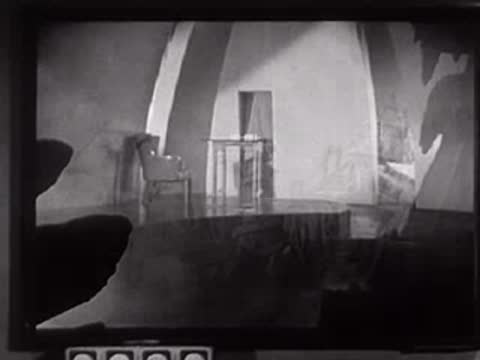 Model of a fantasy castle emerging from clouds in a studio setting.