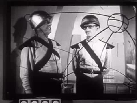 Two people in futuristic uniforms standing and talking in a studio set.