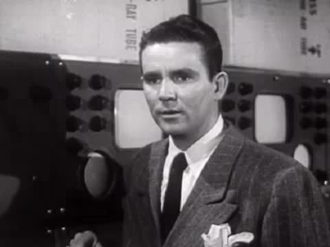 Man in suit looking forward attentively in a laboratory.
