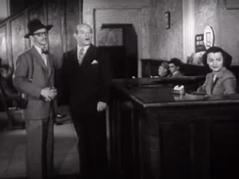 Men walking and meeting inside a building.