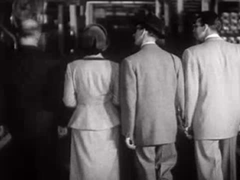 People walking away from the camera in an industrial area.
