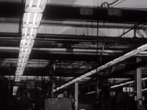 A view of factory ceiling lights and overhead structures.