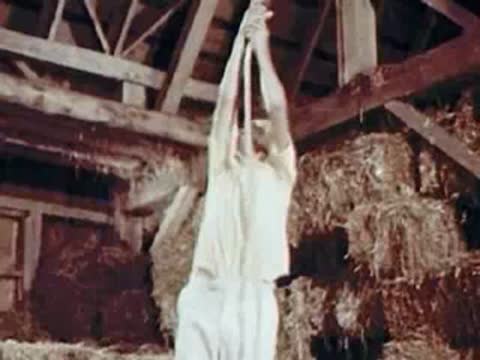 Child pulling a rope in a hayloft