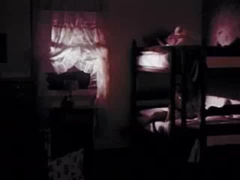 Child getting into the top bunk bed in a bedroom