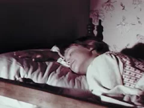 Child sleeping peacefully in bed, close-up shot
