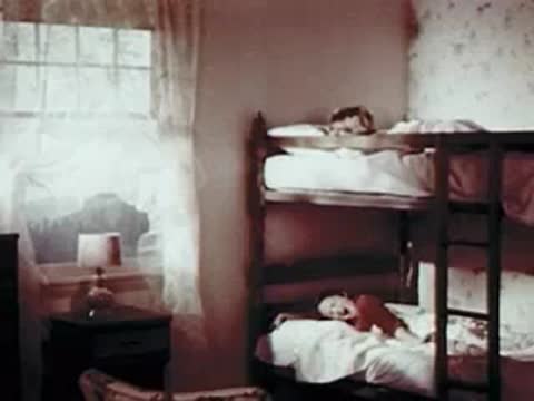 Children sleeping in bunk beds in a rustic bedroom