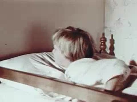 Child waking up in bed and stretching