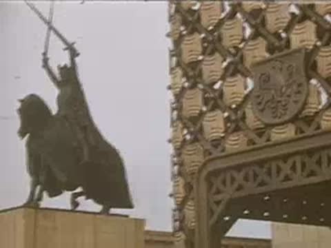 A medium shot of a statue of a knight on a horse holding a sword.