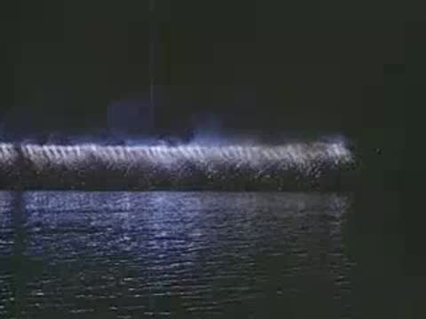 Various nighttime shots of fireworks lighting up the sky and water.