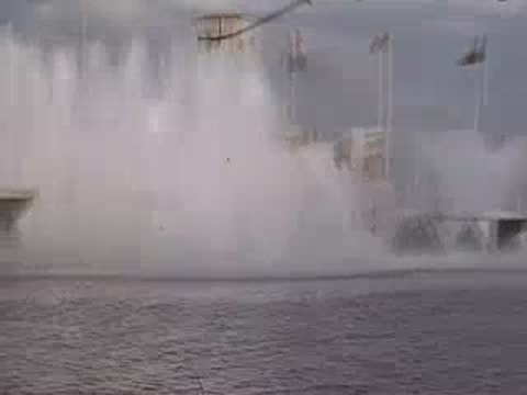 A medium shot of a large fountain spraying water in front of a pavilion.