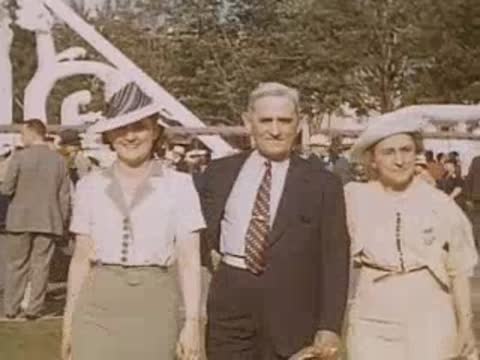 Three people posing together outdoors in period attire and hats