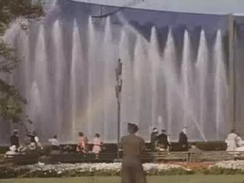 Large water fountain display with a rainbow visible in the mist