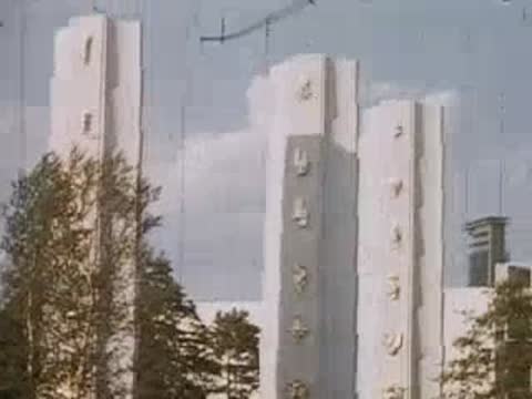Tall white pylons with decorative relief carvings against the sky