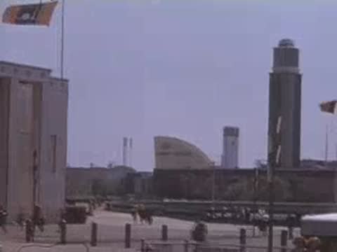 Panning shot showing the Canada pavilion and the Trylon and Perisphere in the distance.