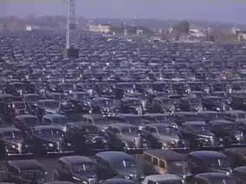 Wide shot of thousands of parked cars stretching into the distance at the fairgrounds.