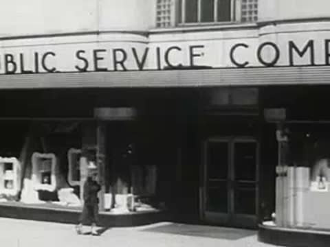 Public Service Company building exterior with a person walking past