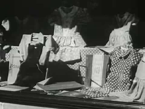 Clothing store window display with dresses and merchandise