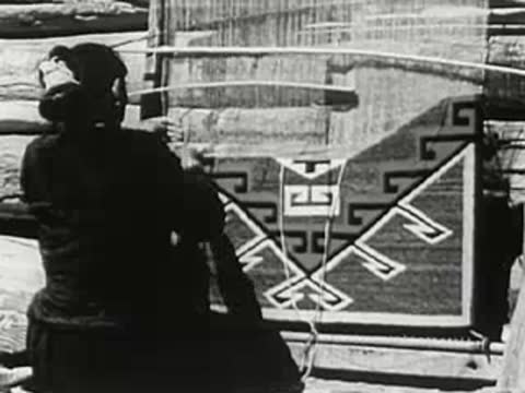 Woman weaving a patterned rug on a traditional loom