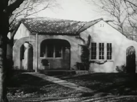 Exterior of a single-story suburban house with tiled roof and trees