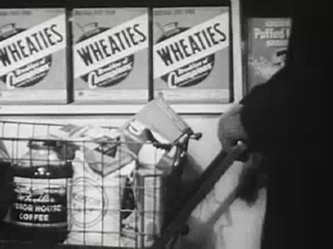 Grocery store aisle with cereal boxes and cart, mid-20th century