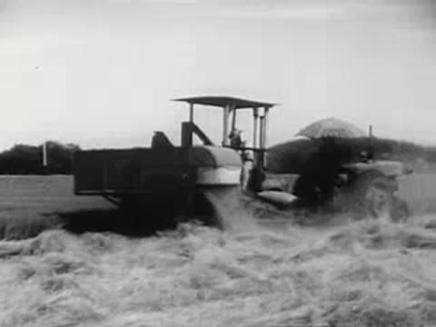 Tractor working a field, agricultural machinery in operation, 1940s