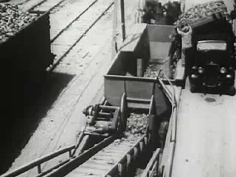 Industrial site with truck and conveyor belt loading material
