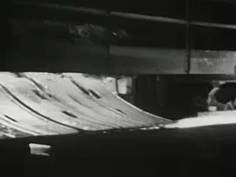 Hot metal processing in industrial manufacturing plant, glowing steel