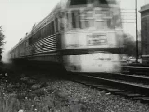 Streamliner passenger train moving along tracks, 1940s.