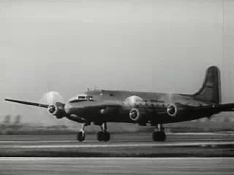 Propeller airplane on airfield runway, 1940s.