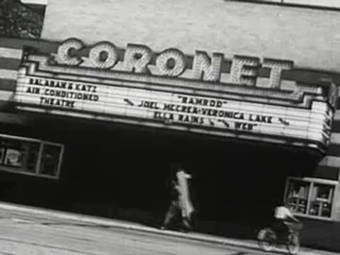Coronet theater marquee on city street, 1940s.